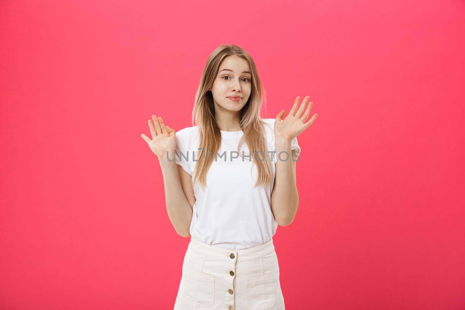 Displeased female model with freckled skin, raises eyebrows and frowns face, makes refusal gesture, says No. Discontent European woman indoor.