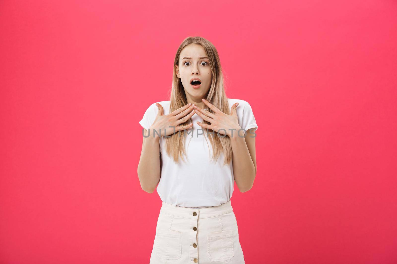 Surprised teenage student girl show shocking expression with something. Isolated on Bright Pink Background. Copy space.