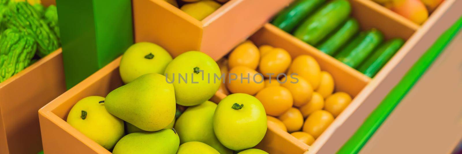 Vegetables and fruits in a toy supermarket. BANNER, LONG FORMAT