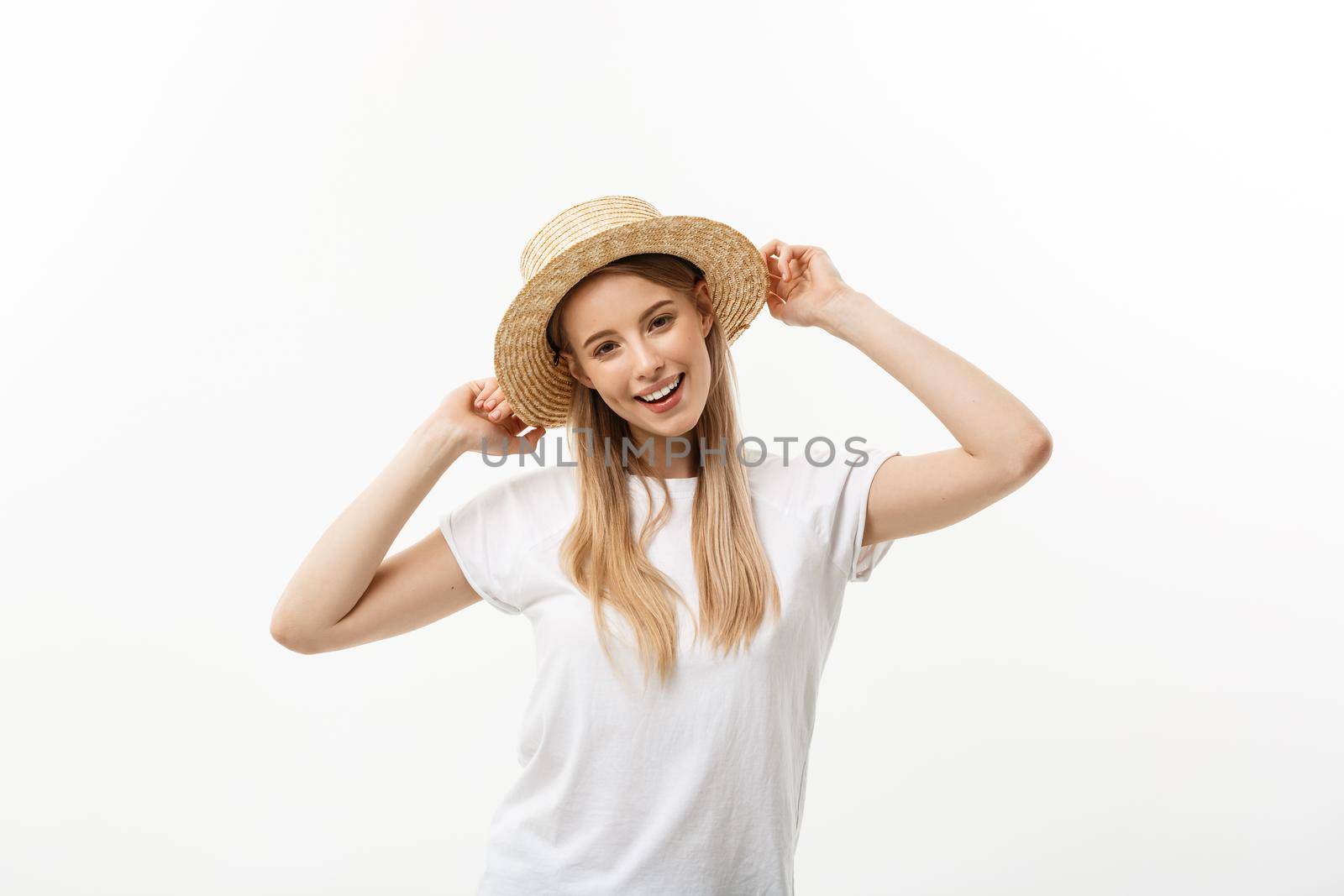 Happiness. Happy summer woman isolated in studio. Energetic fresh portrait of young woman excited cheering in wearing beach hat