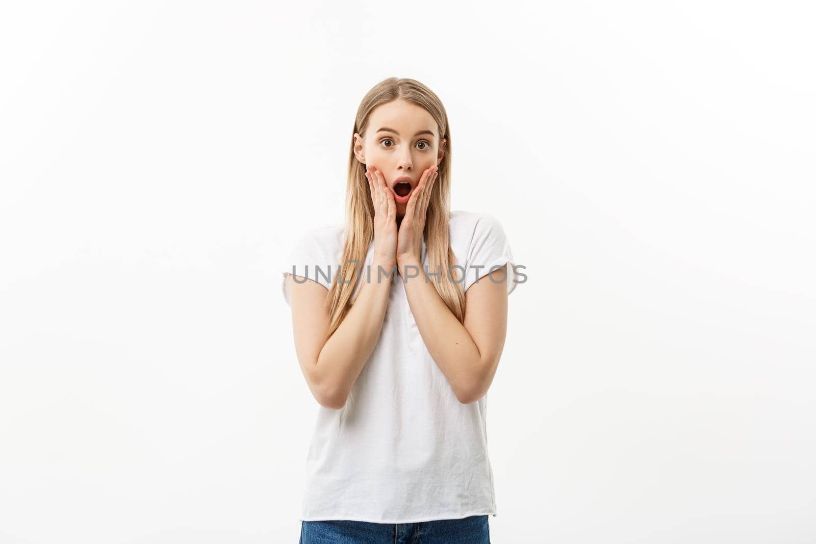 Lifestyle Concept: Portrait of a scared frightened girl standing and surprising facial expression isolated over white background. by Benzoix