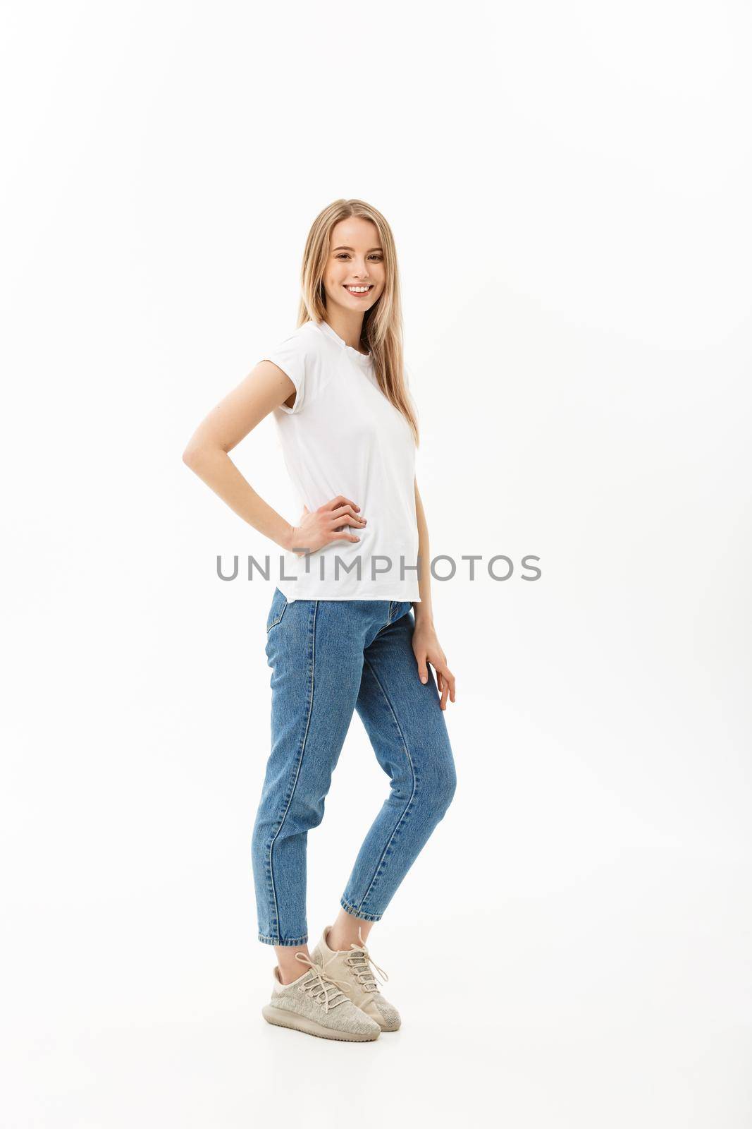 Beautiful standing woman model posing isolated on a white background.