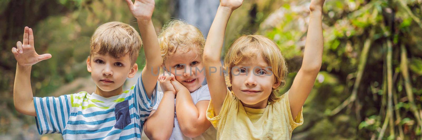 Children rest during a hike in the woods. BANNER, LONG FORMAT