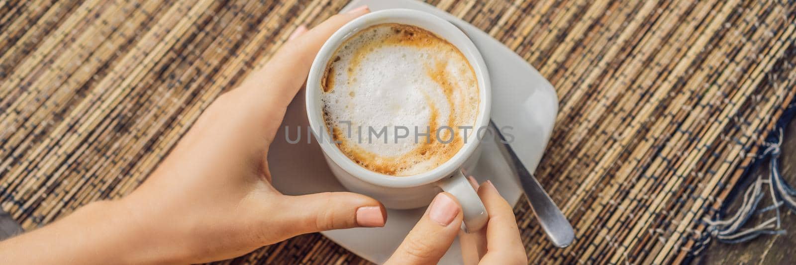 Young woman drinks coffee in a cafe in the mountains. BANNER, LONG FORMAT