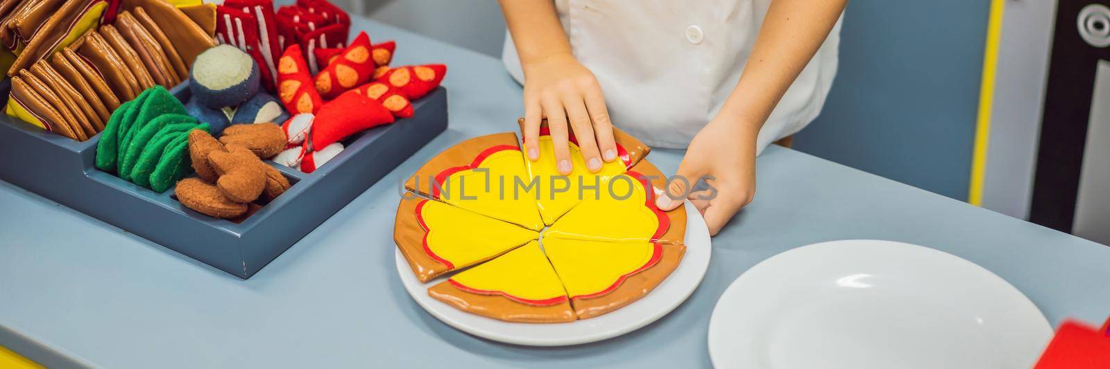 The boy plays in the toy kitchen, cooks a pizza BANNER, LONG FORMAT by galitskaya