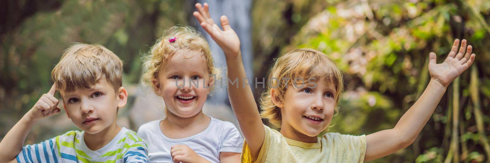 Children rest during a hike in the woods. BANNER, LONG FORMAT