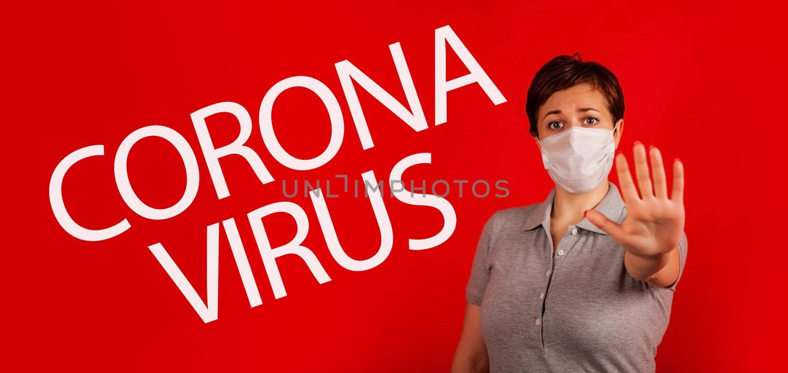 A woman in a mask indicates stopping the spread of the COVID-19 virus. The concept of preventing the spread of the epidemic and treating coronavirus. Coronavirus treatment.