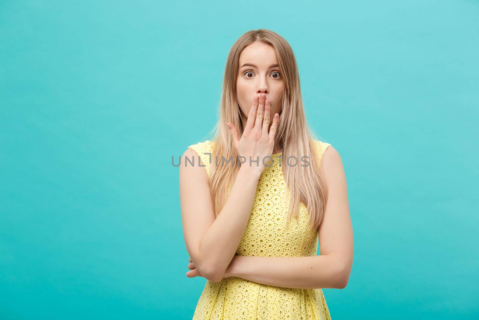 Close up Portrait young beautiful attractive girl shocking with something. Blue Pastel Background. Copy space. by Benzoix