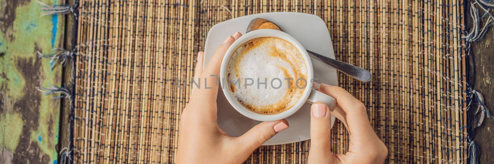 Young woman drinks coffee in a cafe in the mountains. BANNER, LONG FORMAT