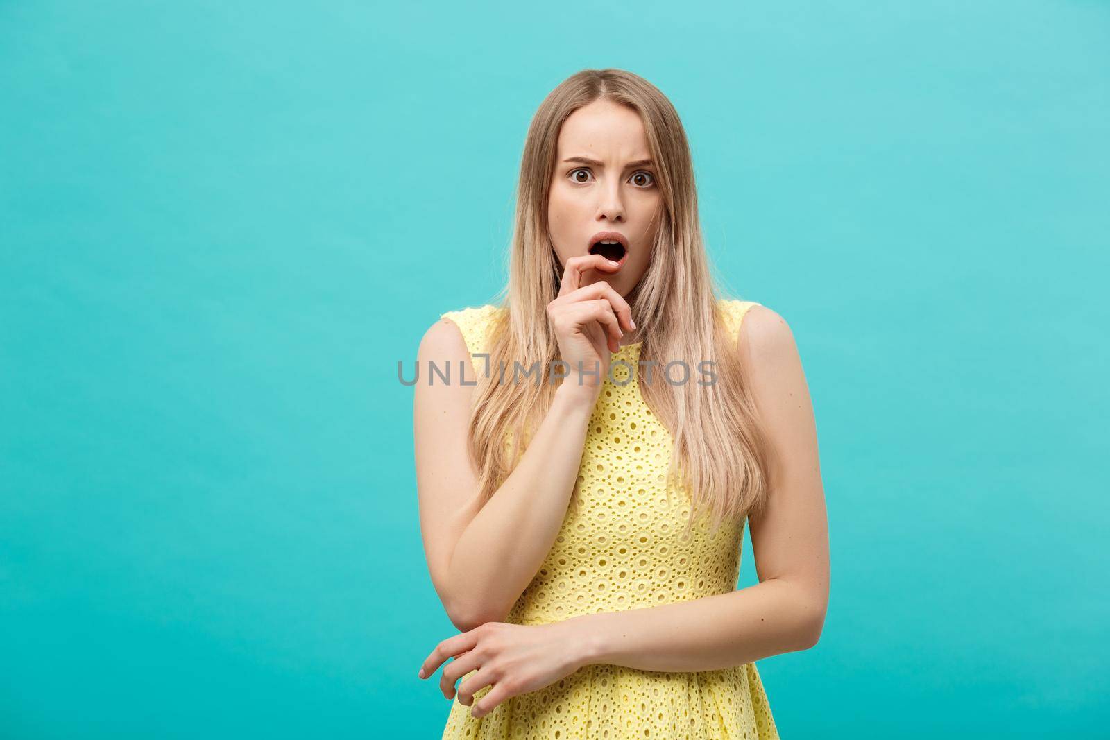 Close up Portrait young beautiful attractive girl shocking with something. Blue Pastel Background. Copy space. by Benzoix