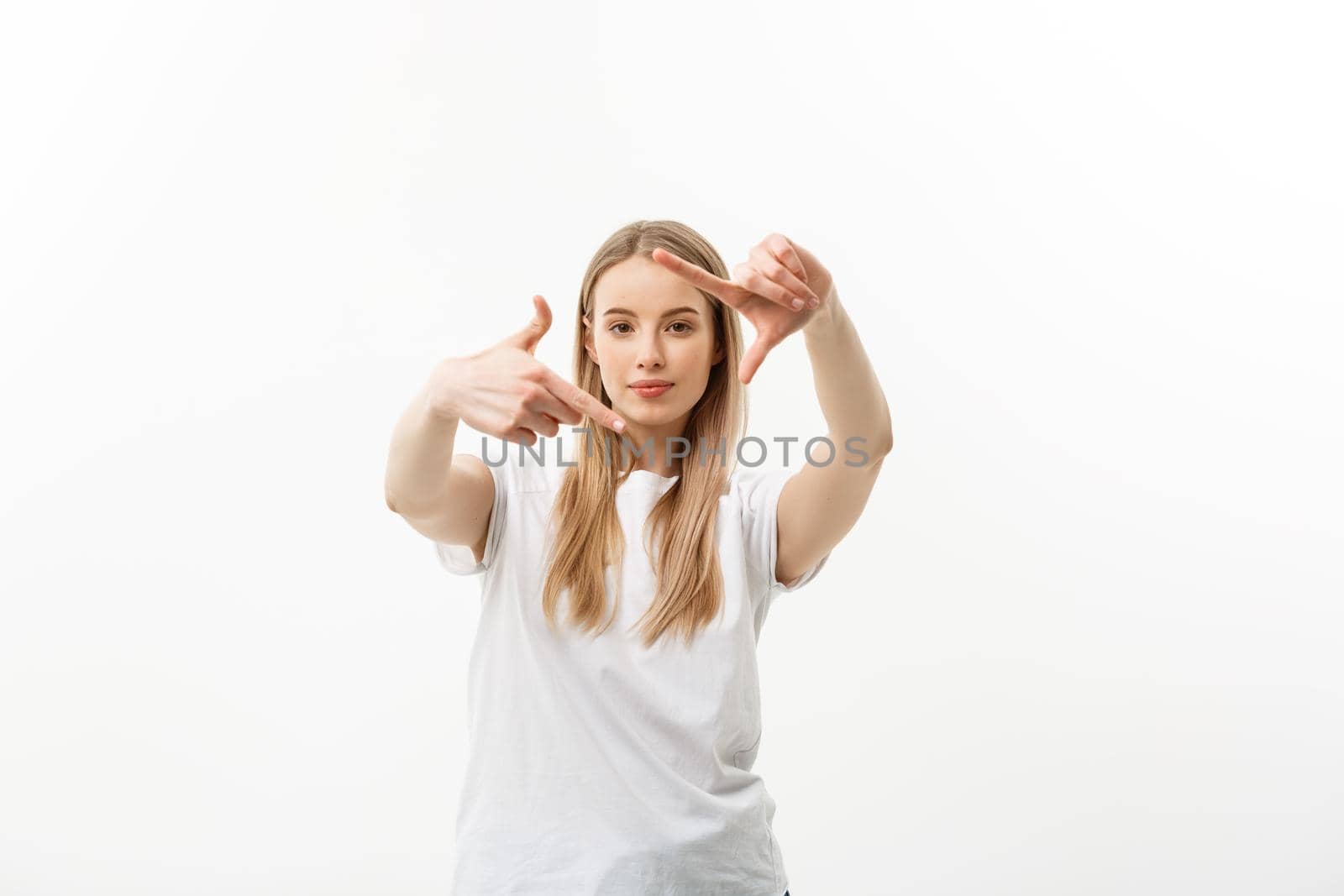 Portrait of young beautiful caucasian woman with cheerfuly smiling making a camera frame with fingers. Isolated on white background. Copy space