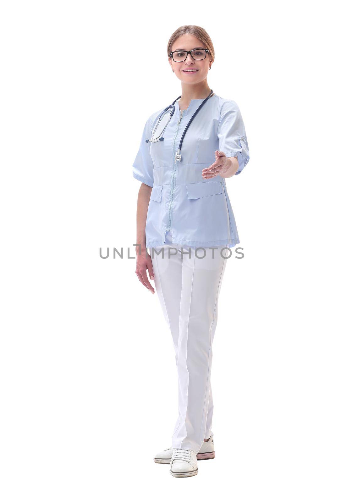 in full growth. friendly female doctor extending her hand for a handshake. isolated on white