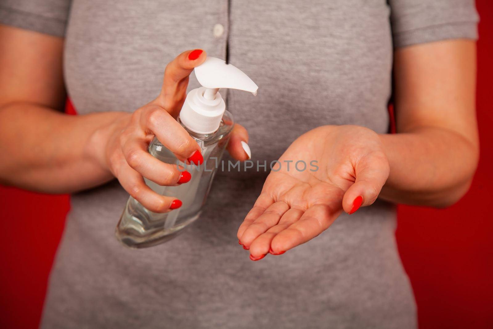 A woman uses a gel, disinfectant, antiseptic. Hand sanitizer prevents viral and plague infections, prevents the appearance of the Kovid-19 virus.