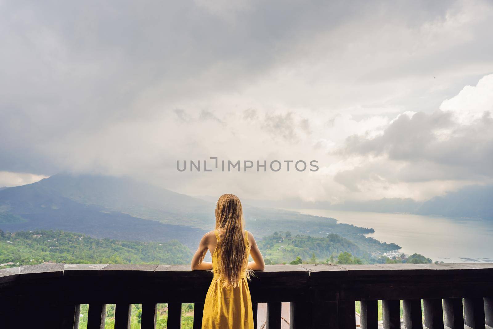 Woman traveler looking at Batur volcano. Indonesia.