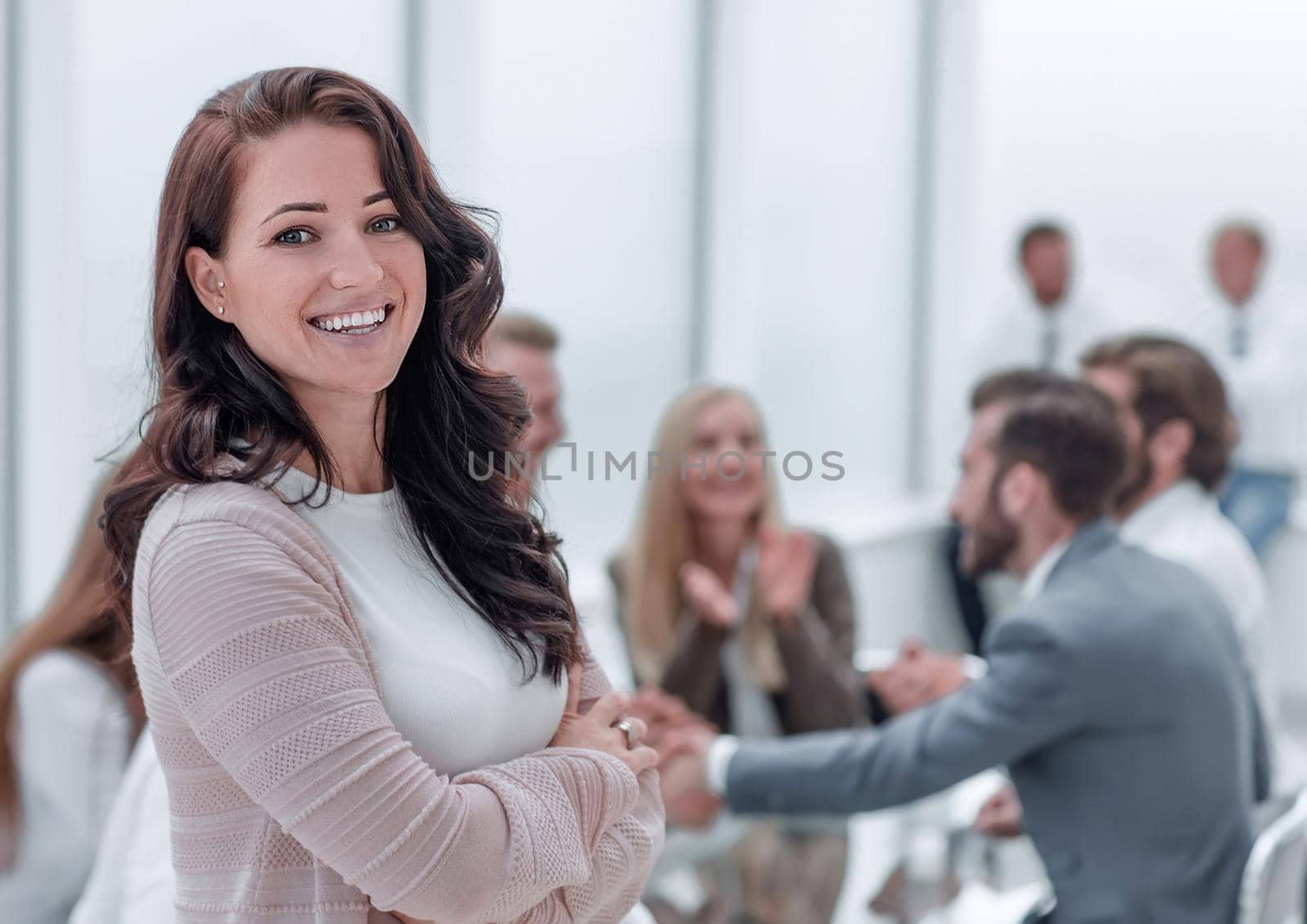 close up. smiling young business woman standing in office. photo with copy space