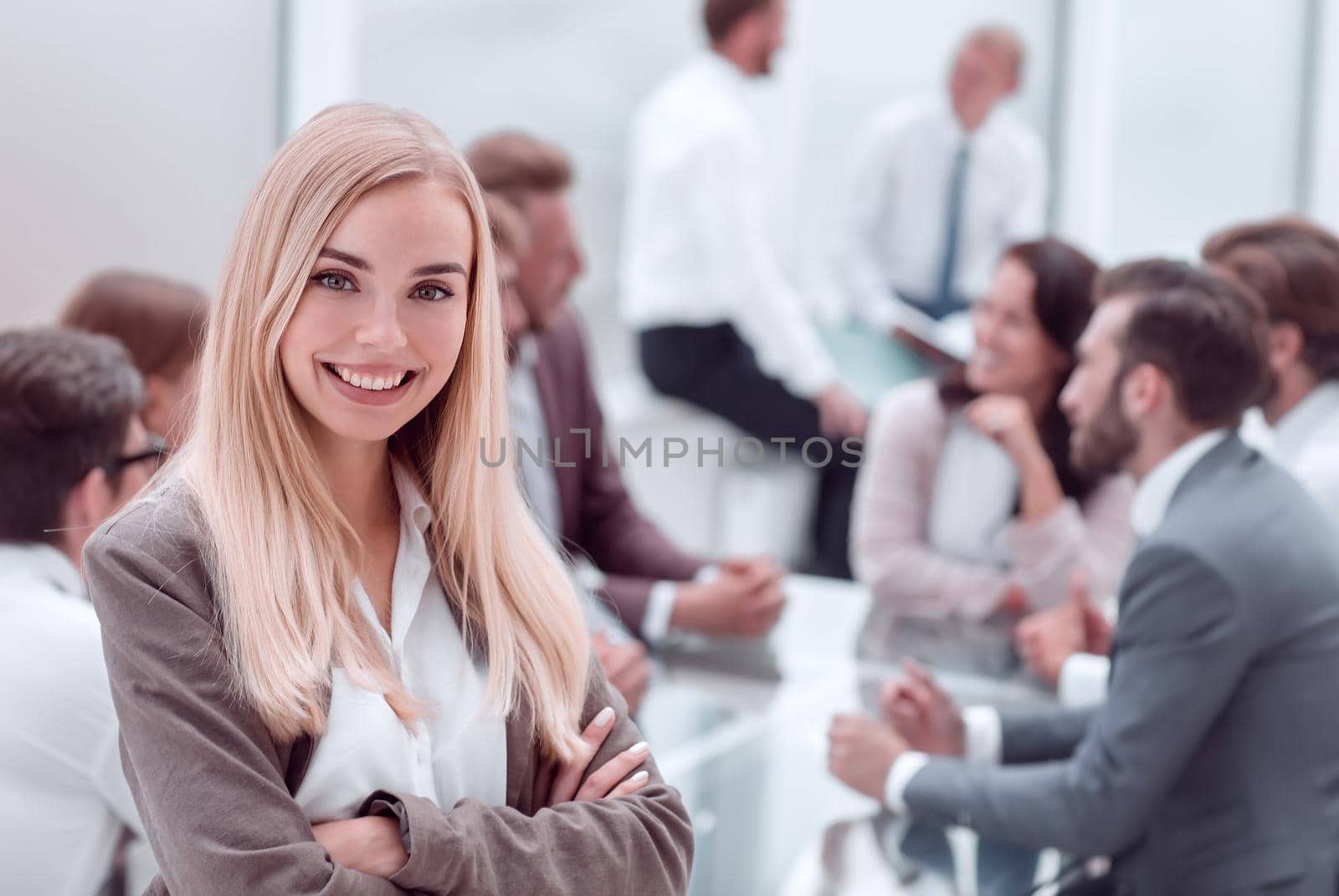 close up. smiling young employee standing in the office. photo with copy space