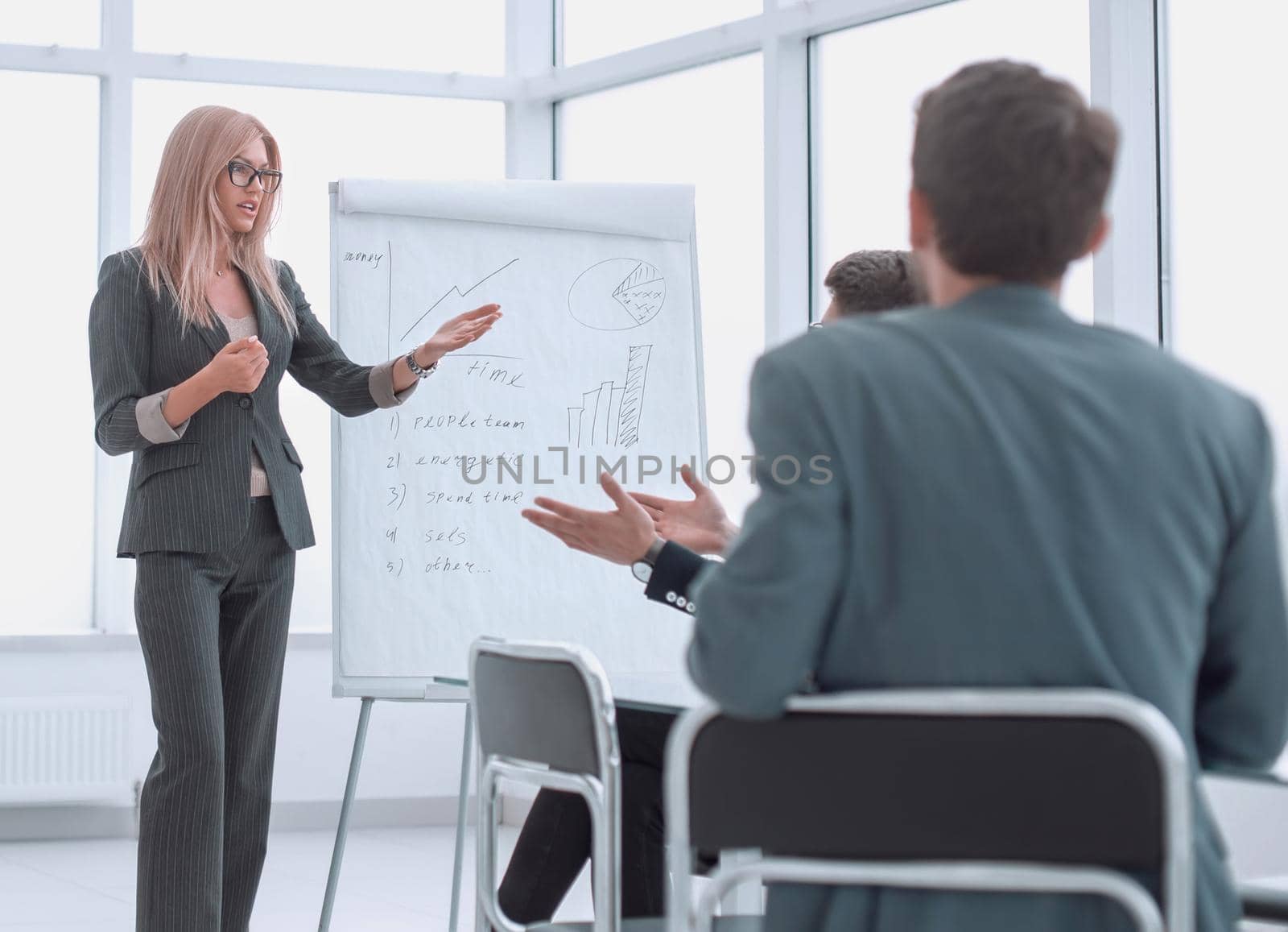 businesswoman makes a presentation of the new project in a spacious conference room