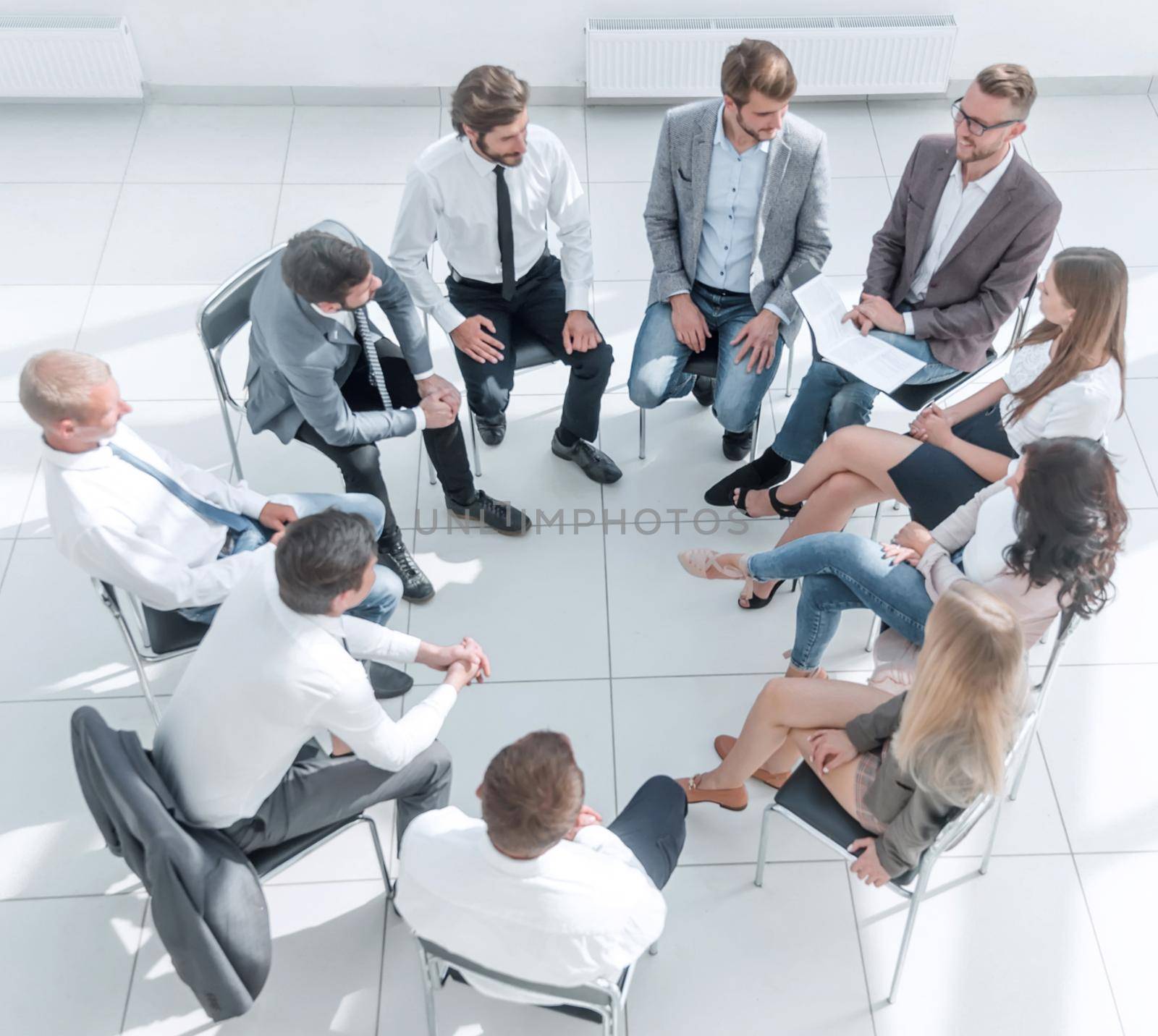 top view. a team of young employees sitting in a circle in the conference room .