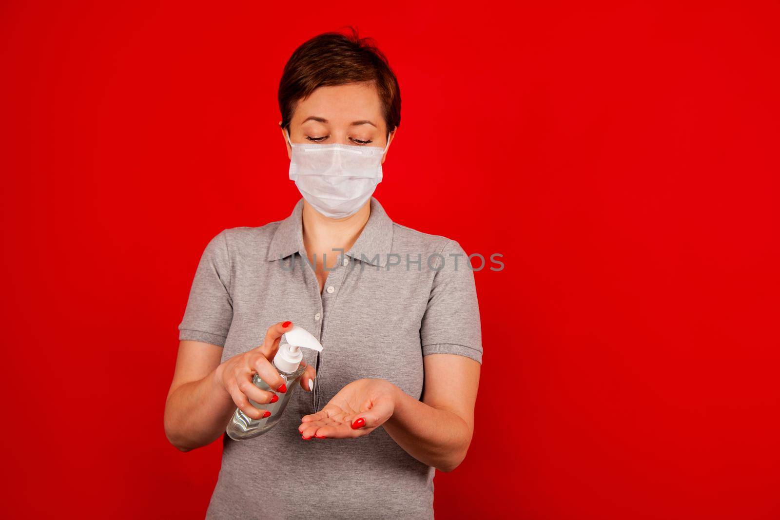 A woman uses a gel, disinfectant, antiseptic. Hand sanitizer prevents viral and plague infections, prevents the appearance of the Kovid-19 virus.