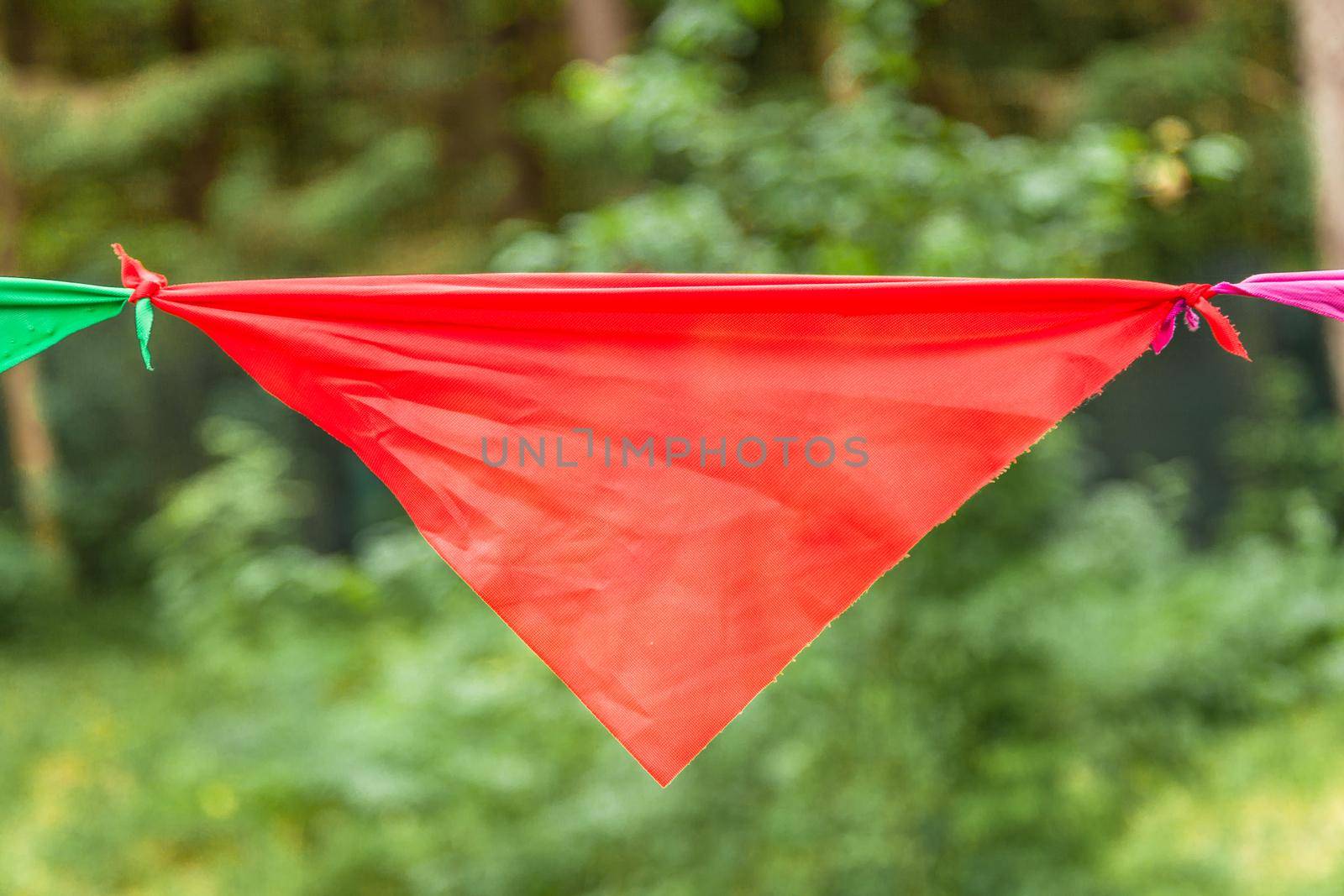 Red flag of a garland in the park