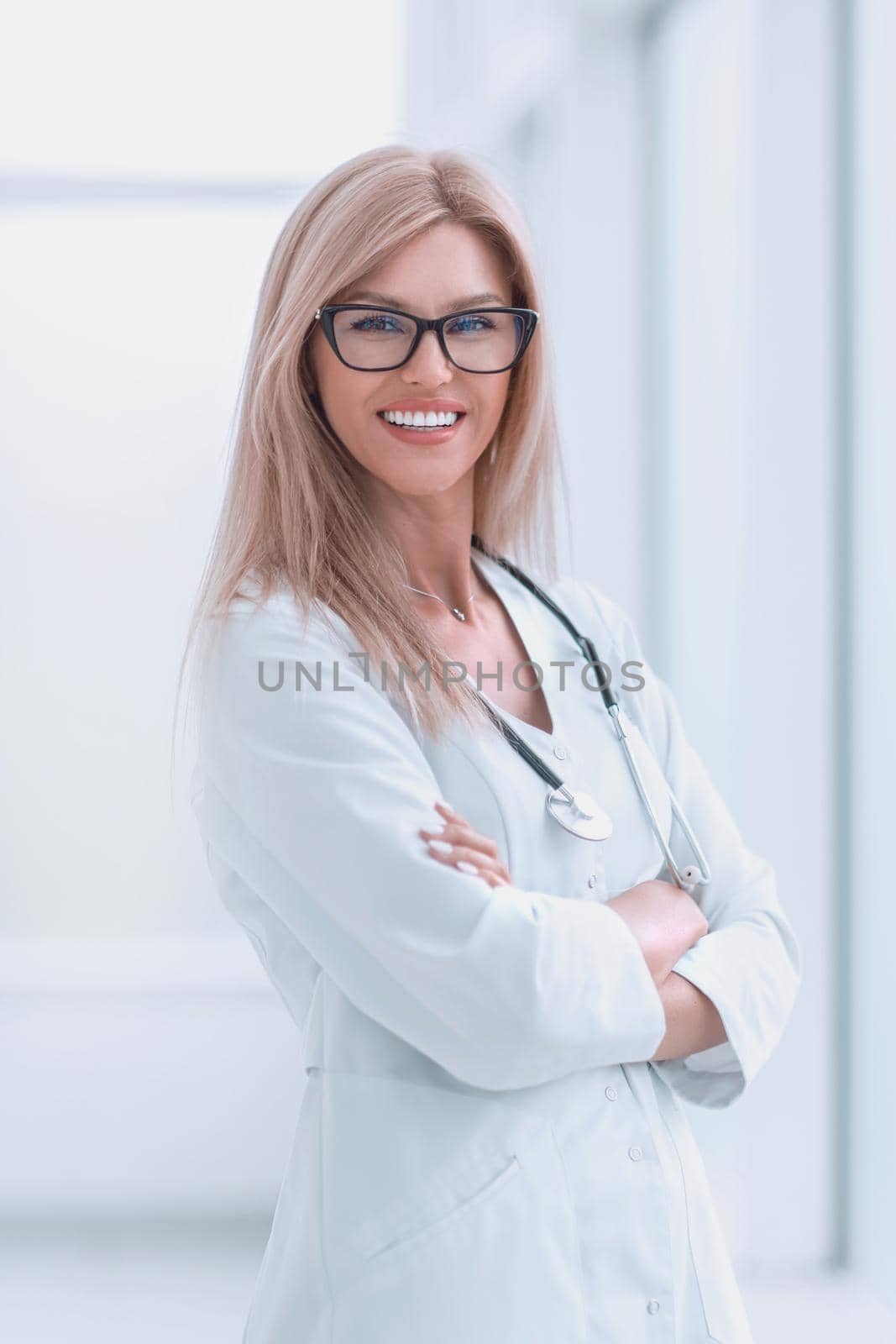 close up. smiling woman doctor standing near the hospital window