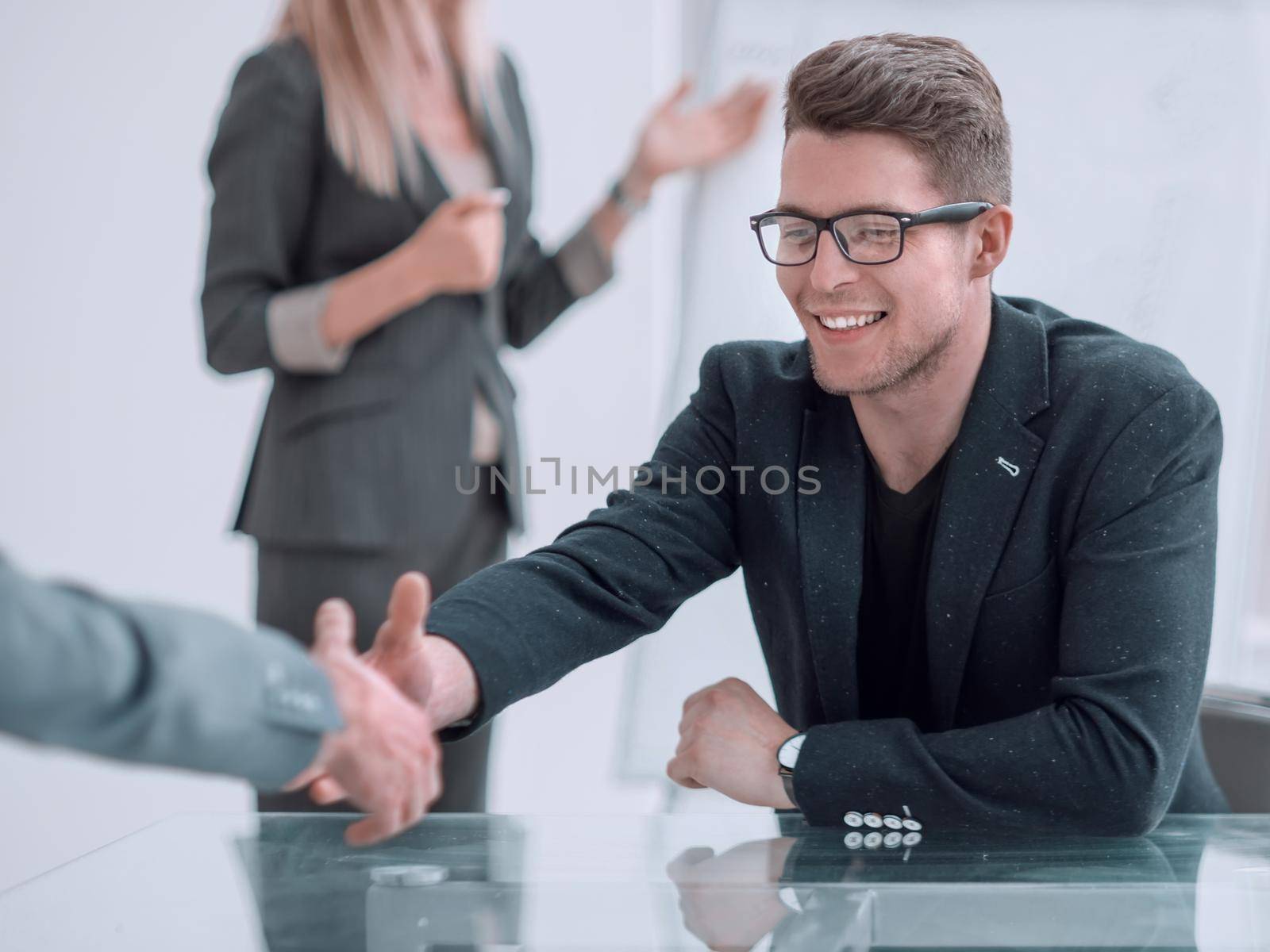 close up. business man shaking hands with his business partner. by asdf