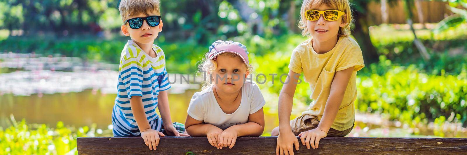 Children rest during a hike in the woods BANNER, LONG FORMAT by galitskaya