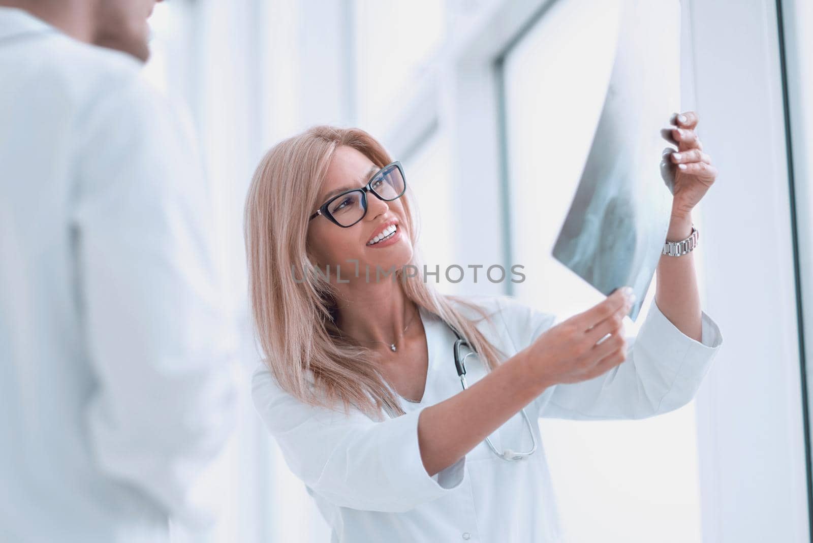 close up. woman doctor looking at x-ray of patient by asdf