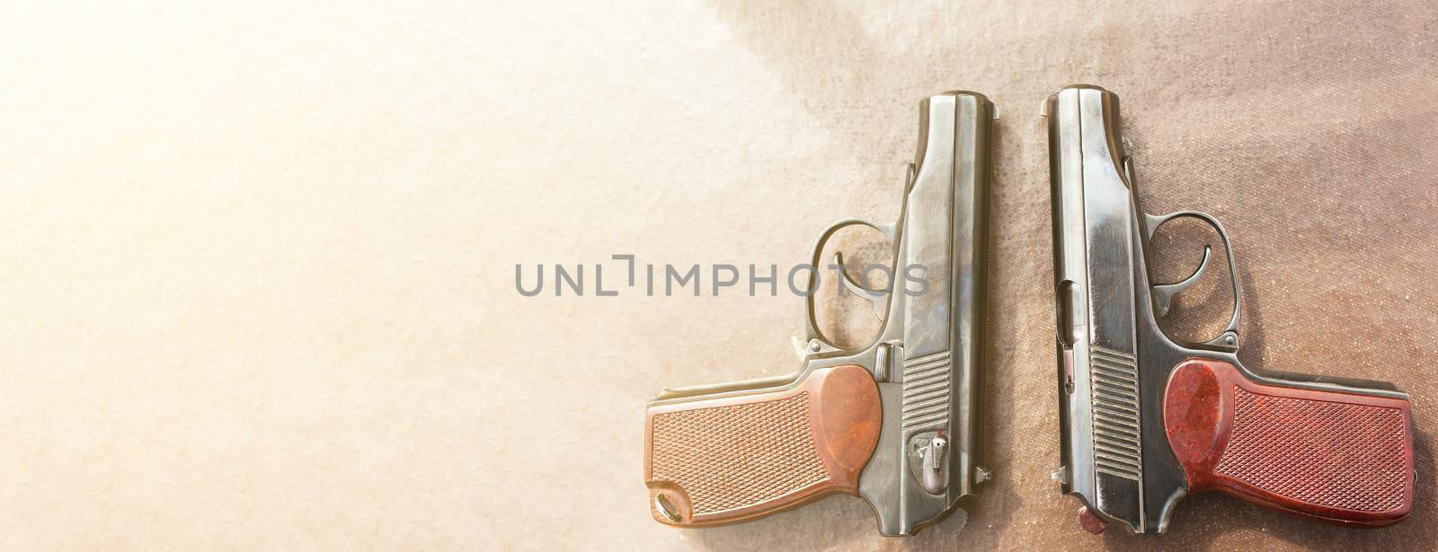 The gun lies on a table on old village boards, legalization of weapons. Crime problems. Weapons for sports and self-defense. Conceptual of violence, homicide, crime and burglary. Copyspace