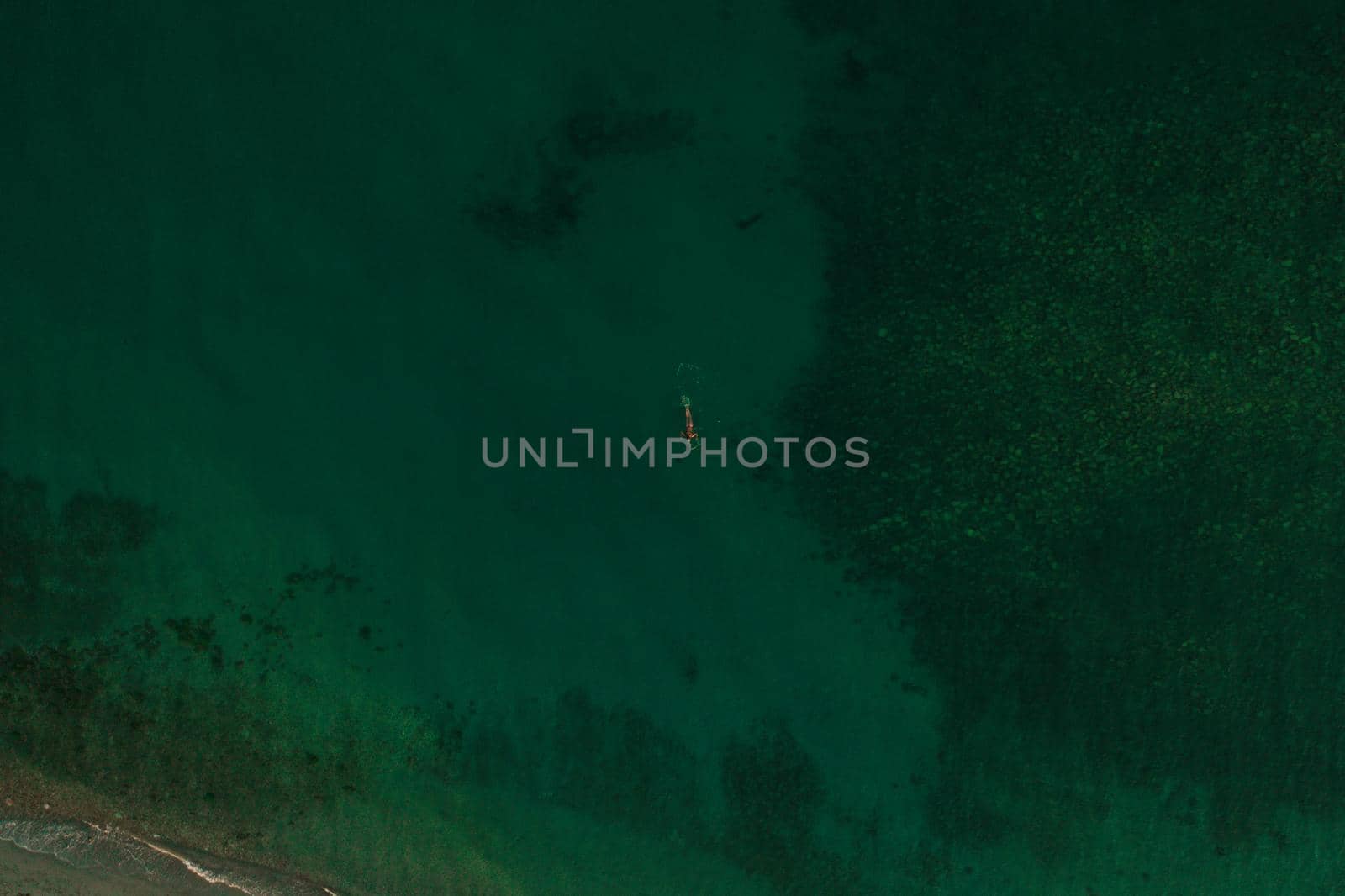 Aerial top nature view above green turquoise Thracian sea Greece Ellada. Beautiful woman bikini by AndriiDrachuk