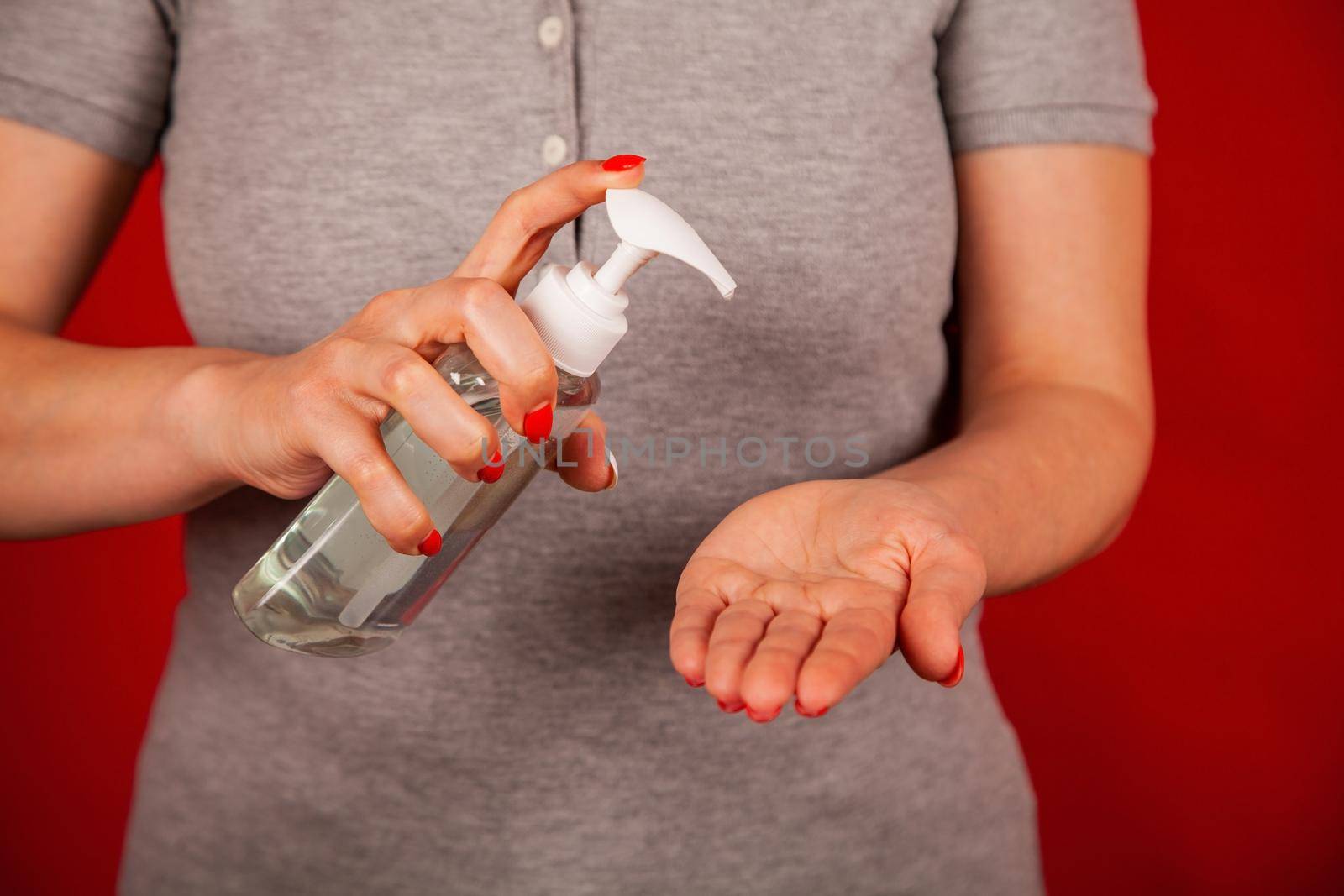 A woman uses a gel, disinfectant, antiseptic. Hand sanitizer prevents viral and plague infections, prevents the appearance of the Kovid-19 virus.