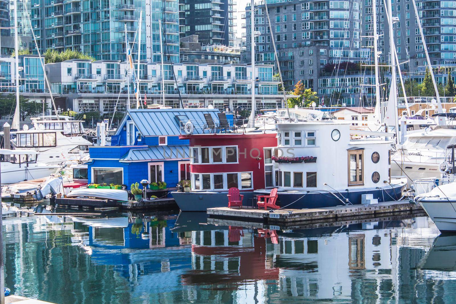 Houseboats docked in the marina at the Coal Harbour waterfront by JuliaDorian