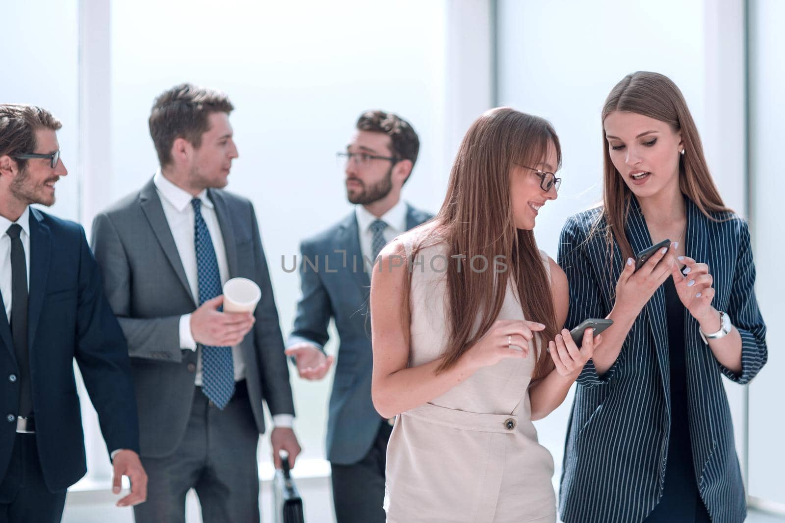 young employees exchanging information in the office lobby. office weekdays