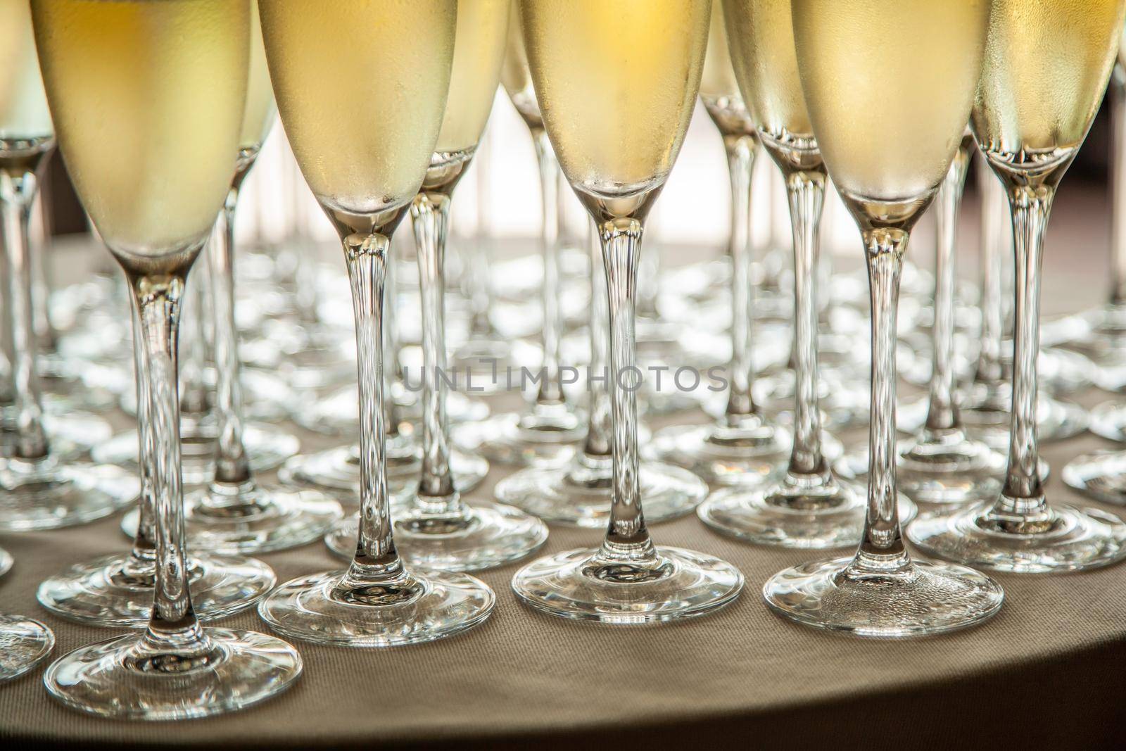 Glasses with cold champagne at the event.