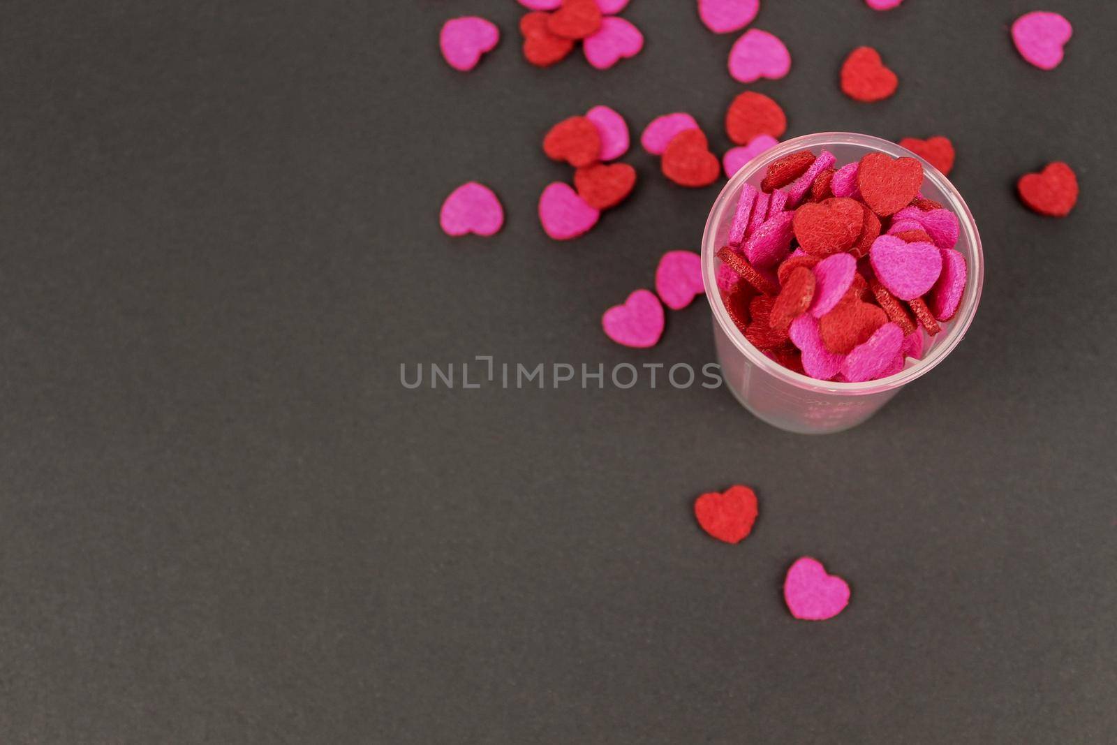Red Pink Heart Candy in Transparent Cup Dark Background Love Valentine Concept