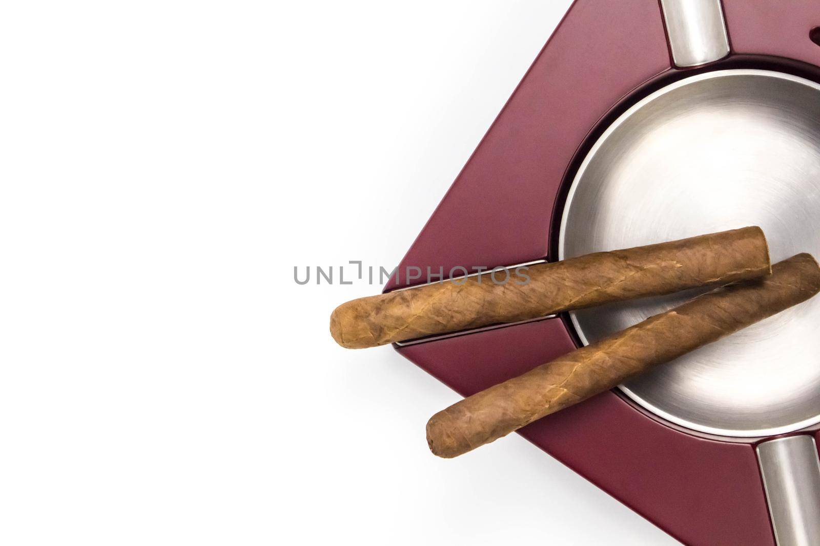 Cuban cigar in ashtray. View from above on white background. by JuliaDorian