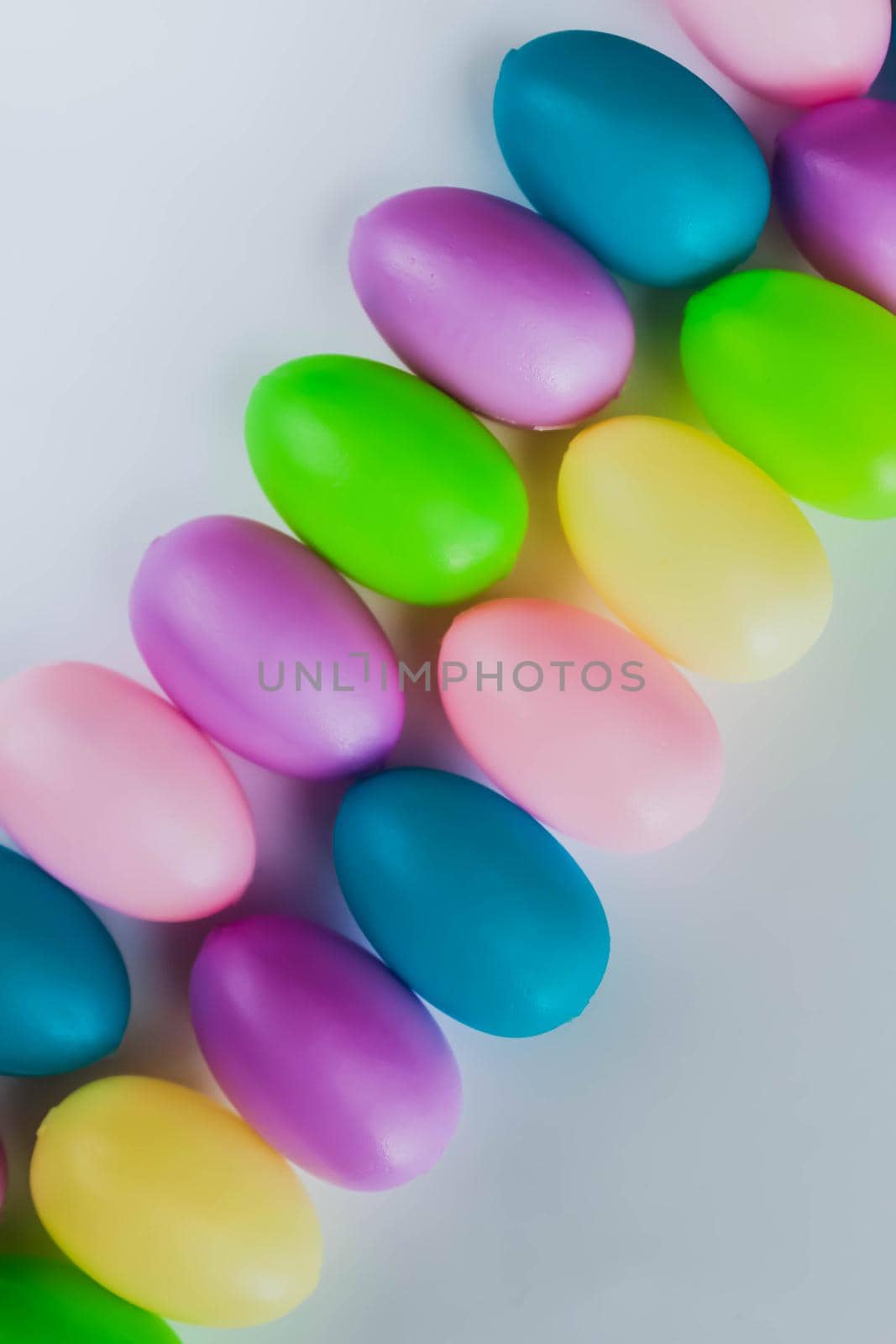 Colorful plastic Easter eggs on white