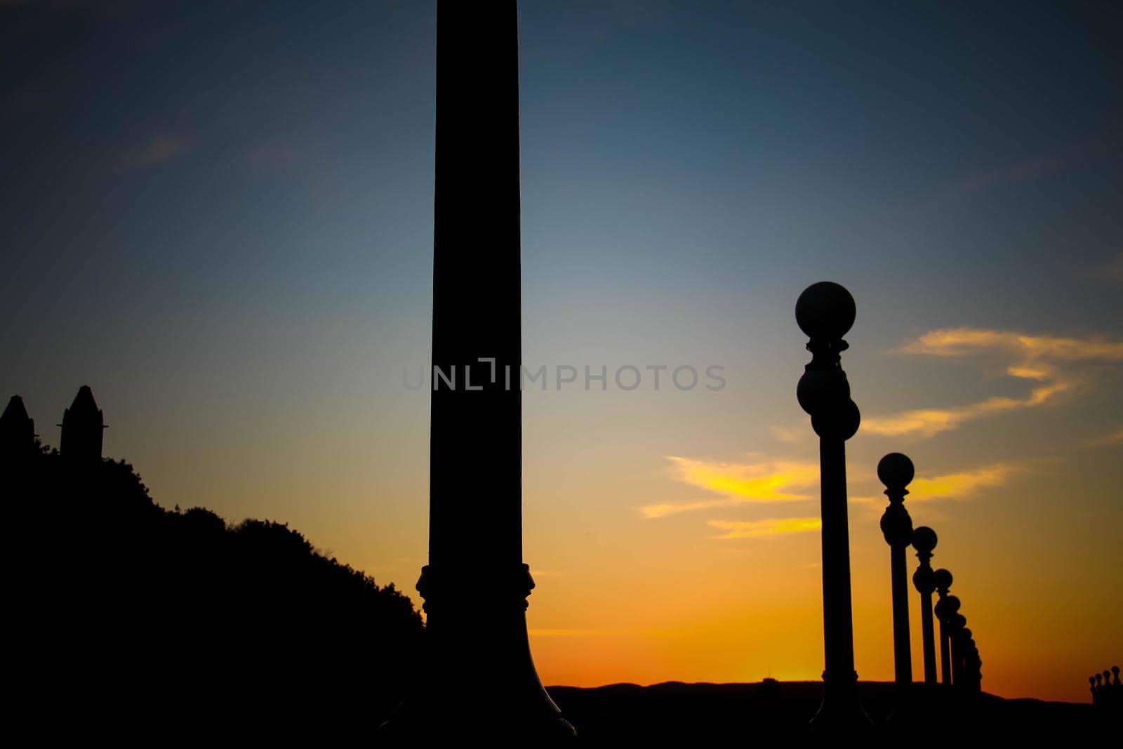 Silhouette of street lanterns with sunset sky. Silhouette of a street lamp post during a beautiful sunset. by JuliaDorian