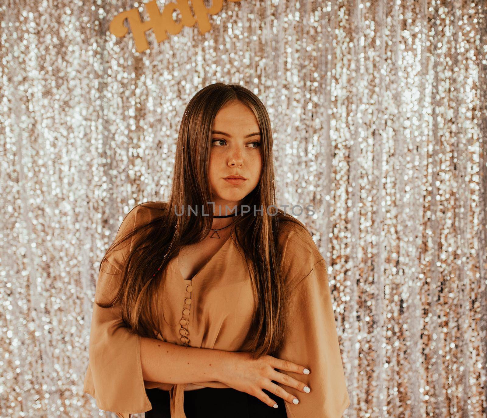 Ukrainian young woman in a mini skirt. Fashion summer 2021 style glamorous. Silver shiny background.