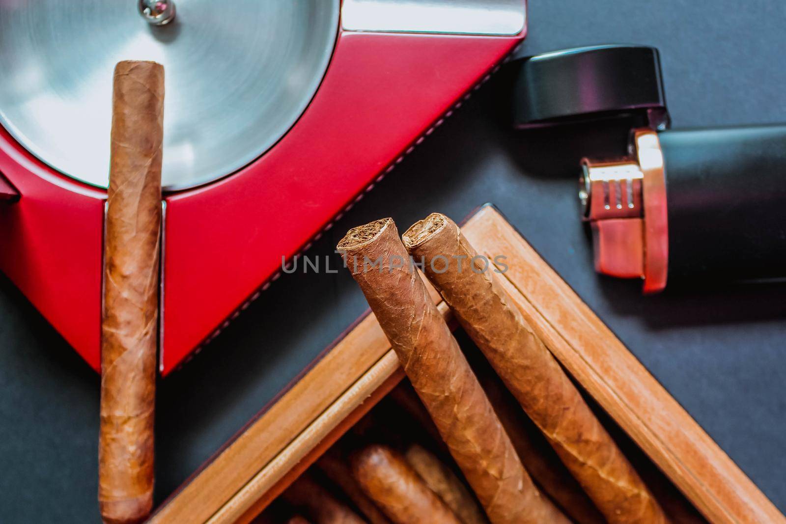 Open humidor with cigars, ashtray and cigar torch. Smoking set accessories. luxury lifestyle flat lay top view