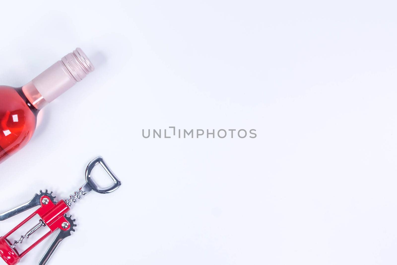 Red, rose and white wine bottles on white table. Top view with copy space