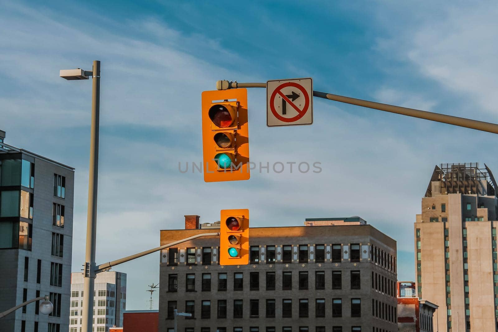 View of traffic lights and city buildings at sunny day. Cityscape view