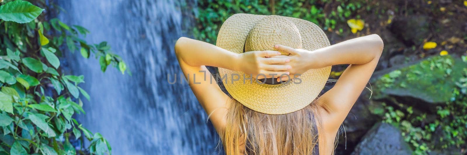 Woman traveler on a waterfall background. Ecotourism concept BANNER, LONG FORMAT by galitskaya