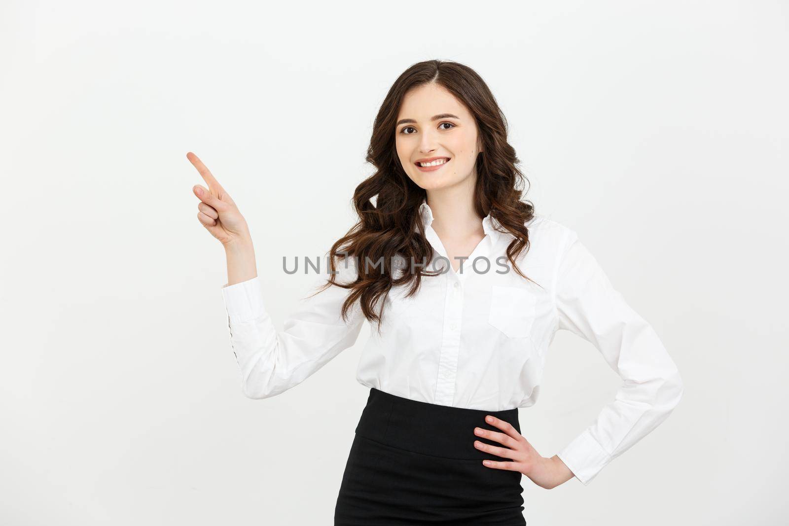 Business Concept Portrait of smiling business woman pointing finger on copy space. iswolated portrait