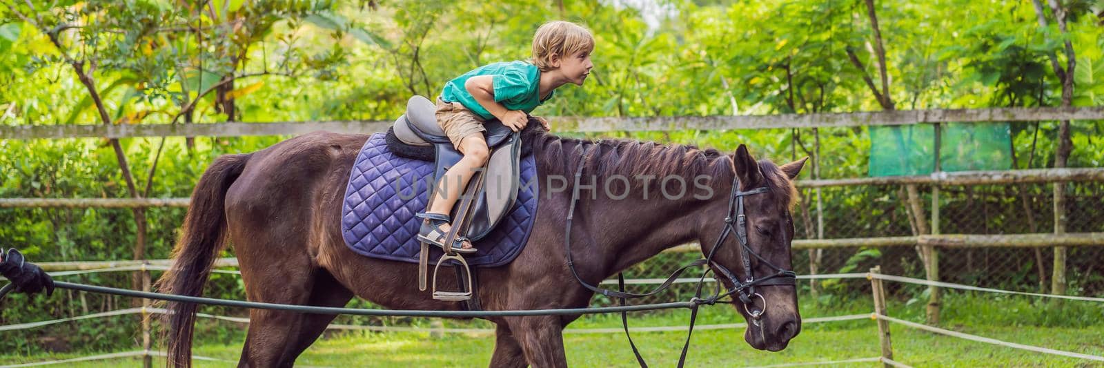 Boy horseback riding, performing exercises on horseback. BANNER, LONG FORMAT