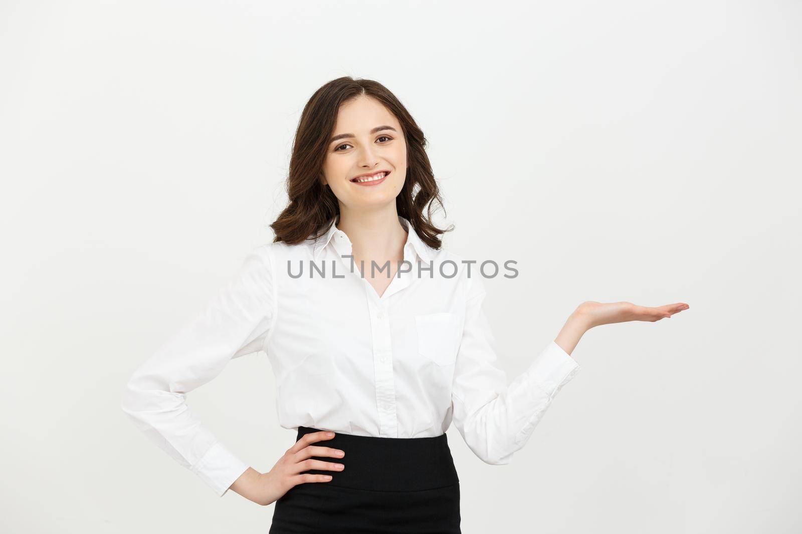 Business woman happy and surprise showing product .Beautiful girl holding hand to the side.