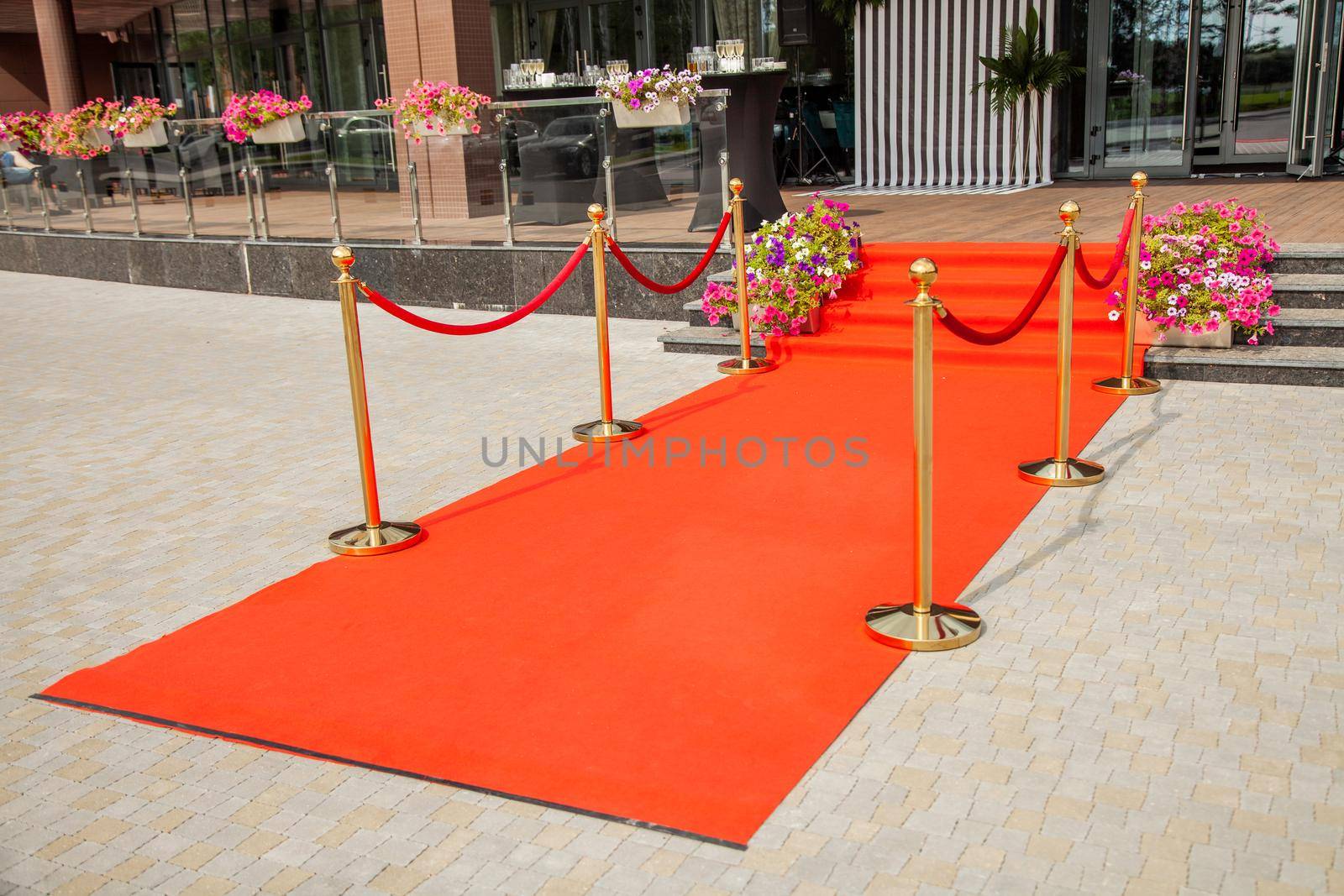 Red carpet with a gold fence entrance to the restaurant.