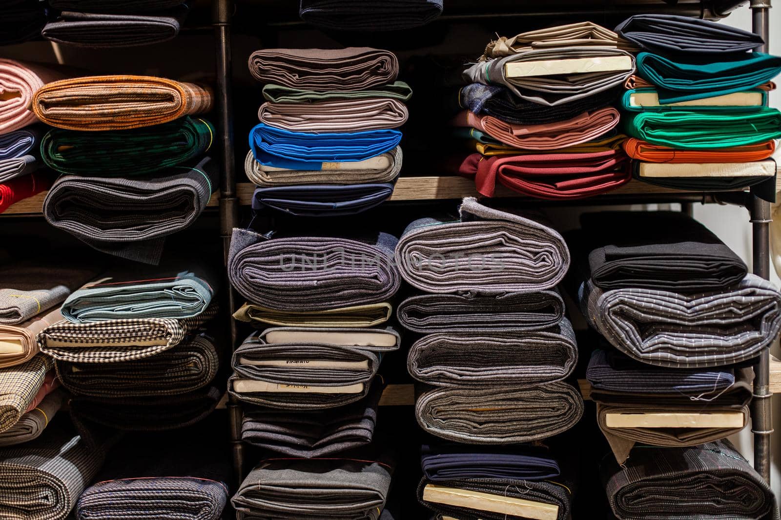Rolls of fabric in stock. Interior of a industrial warehouse with fabric rolls. colorful fabric rolls on textile market