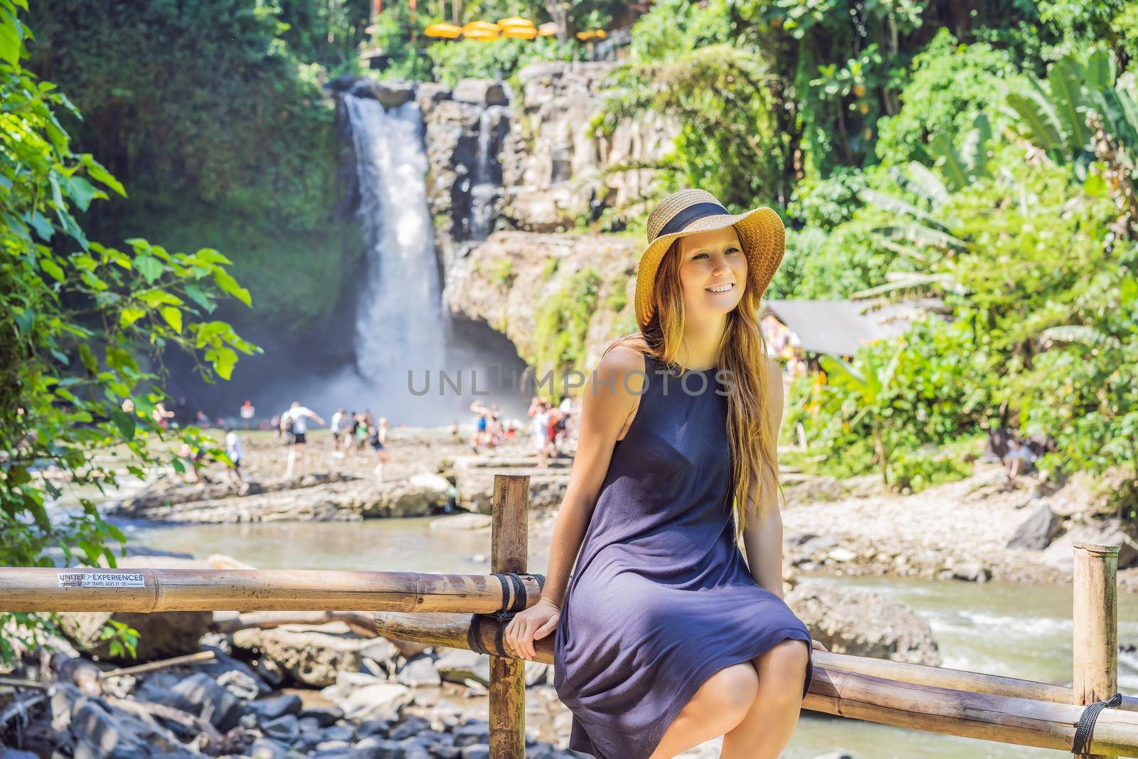 Woman traveler on a waterfall background. Ecotourism concept.