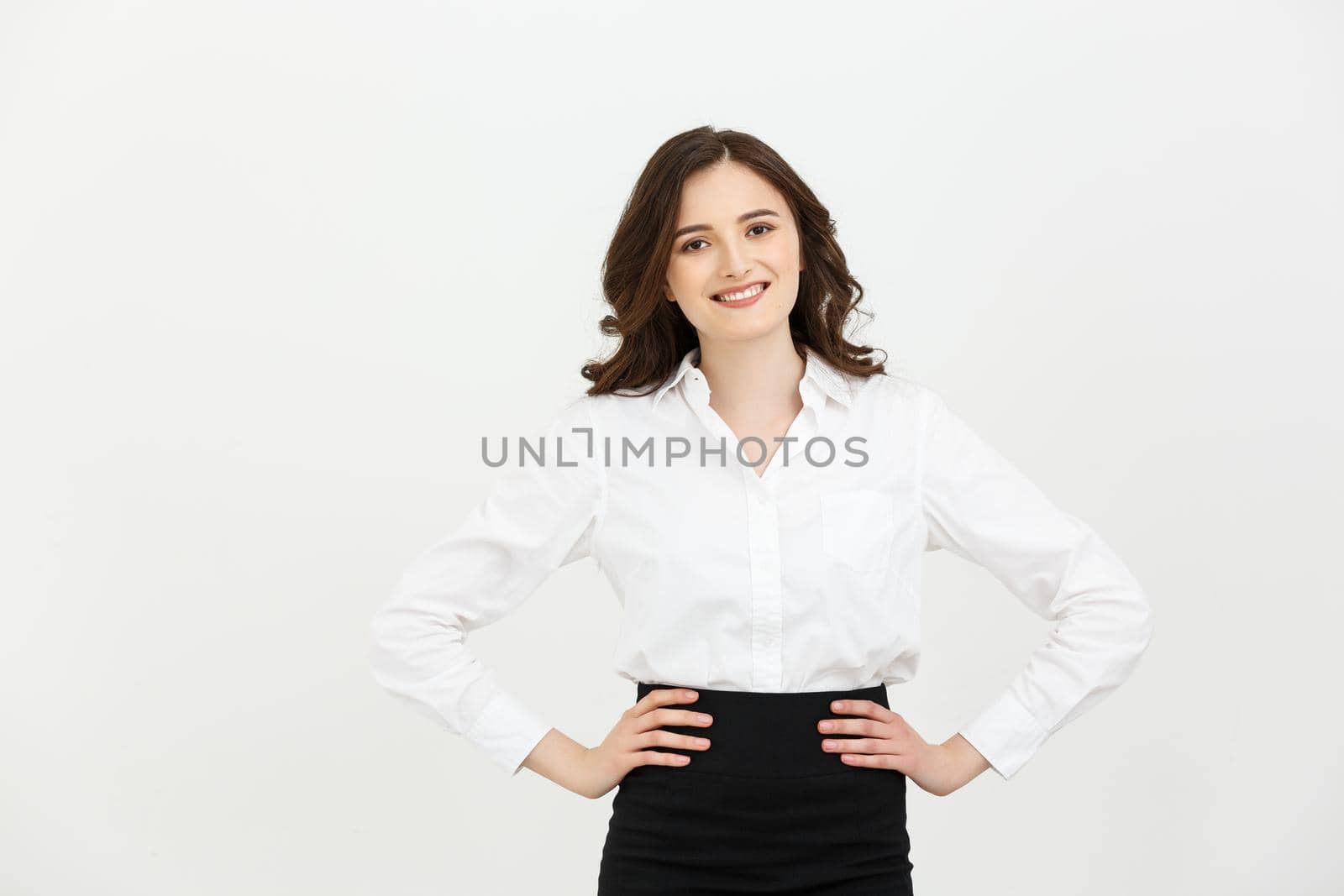 Business Concept: Portrait of Beautiful young business woman posing over white background